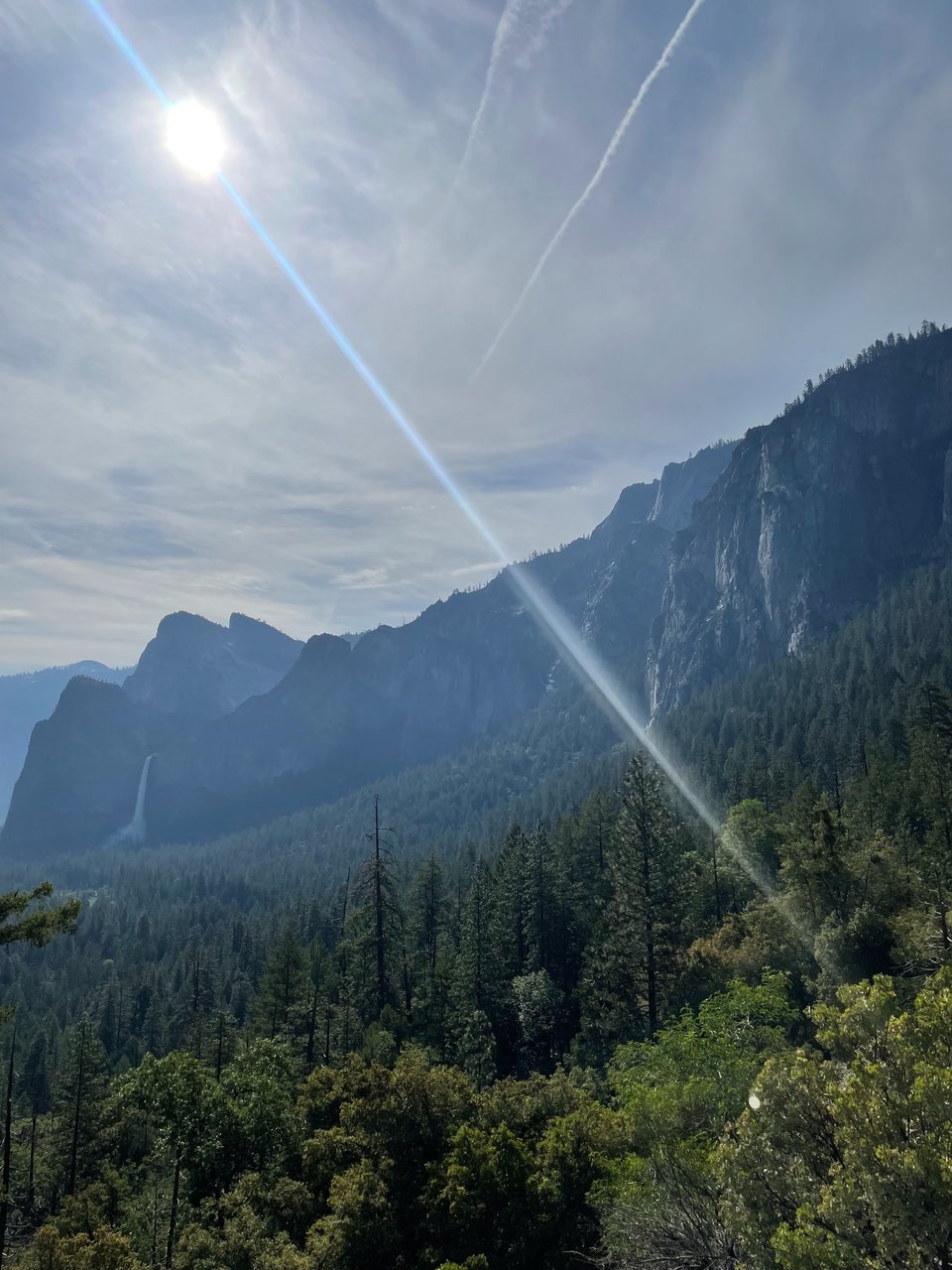 Sunlit mountain valley above a forest